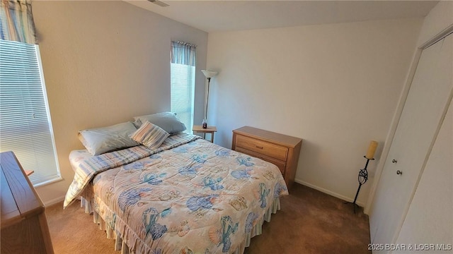 carpeted bedroom featuring baseboards