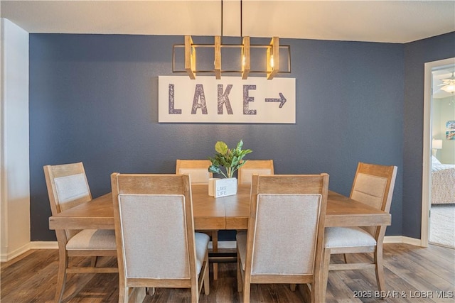 dining room with baseboards and wood finished floors