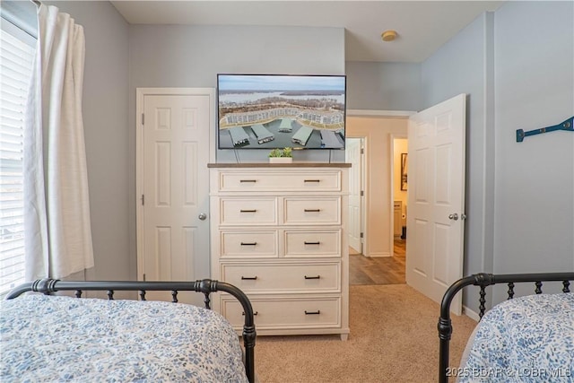 bedroom featuring light colored carpet