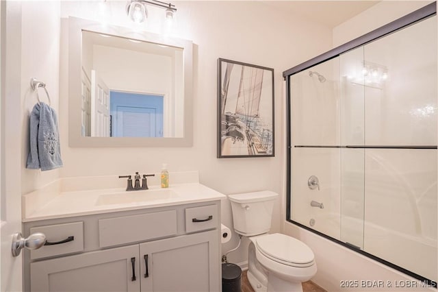 full bath with shower / bath combination with glass door, vanity, and toilet