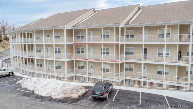 view of property featuring uncovered parking