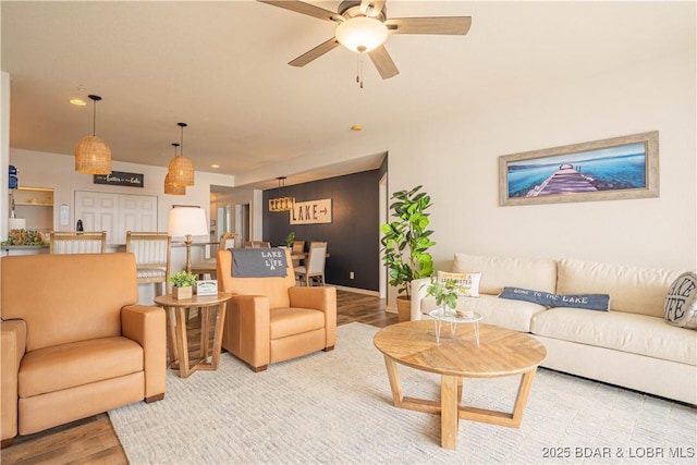 living area with recessed lighting, ceiling fan, baseboards, and wood finished floors