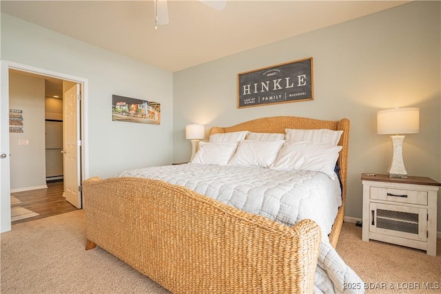 carpeted bedroom featuring ceiling fan and baseboards