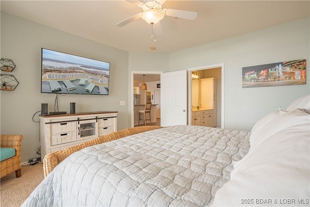 bedroom with carpet floors, ceiling fan, and ensuite bath