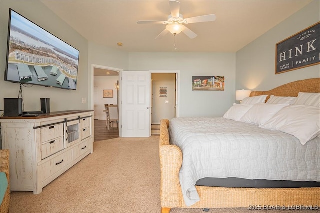 bedroom with light carpet and a ceiling fan