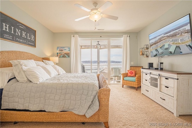 bedroom with light carpet, access to exterior, and ceiling fan