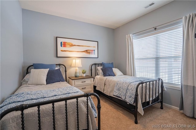 bedroom with light colored carpet, visible vents, and baseboards