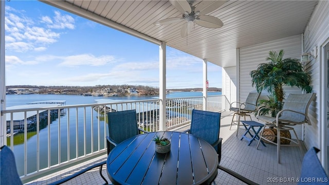 exterior space with outdoor dining area, a water view, and a ceiling fan