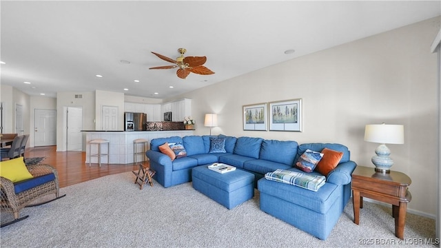 living area featuring ceiling fan and recessed lighting