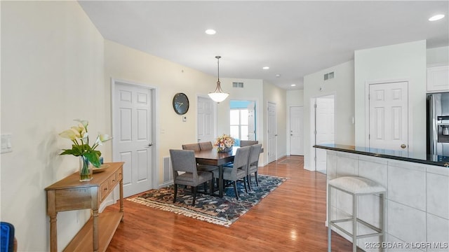 dining space featuring visible vents, wood finished floors, and recessed lighting