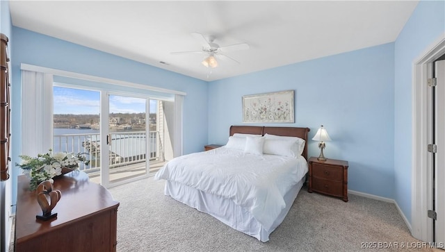 carpeted bedroom with access to exterior, a water view, baseboards, and a ceiling fan