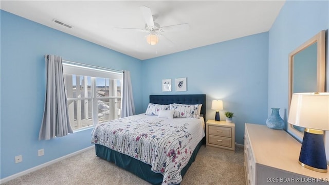 carpeted bedroom featuring baseboards, visible vents, and a ceiling fan