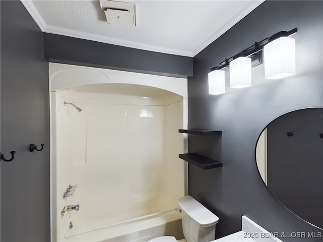 bathroom featuring ornamental molding, tub / shower combination, a textured ceiling, and toilet