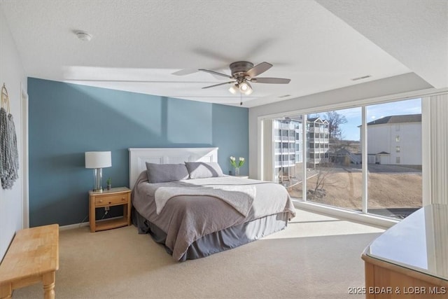 bedroom featuring visible vents, a ceiling fan, carpet flooring, a textured ceiling, and access to outside