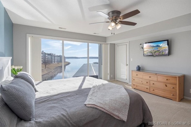 bedroom with visible vents, baseboards, light colored carpet, ceiling fan, and access to outside