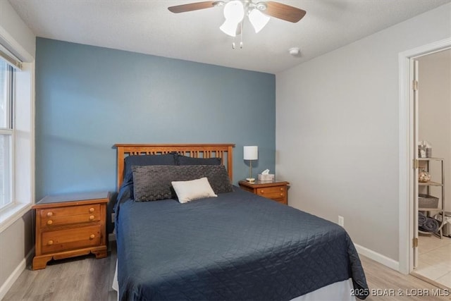 bedroom with wood finished floors, a ceiling fan, and baseboards