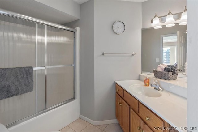 full bath featuring shower / bath combination with glass door, vanity, baseboards, and tile patterned floors