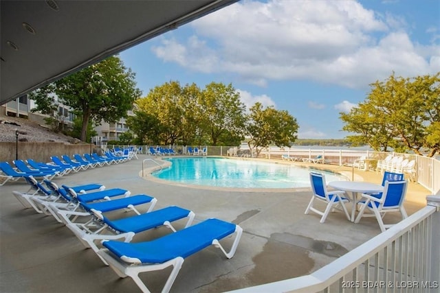 community pool featuring a patio area and fence