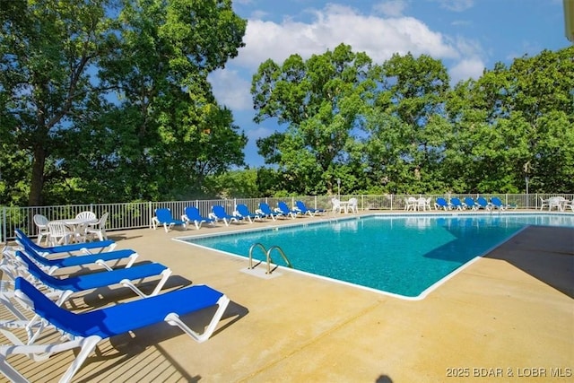 pool with fence and a patio