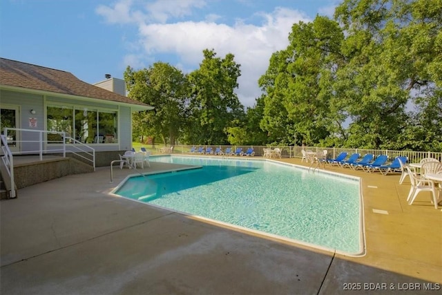 pool featuring a patio and fence