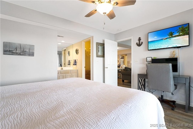 bedroom with ceiling fan, connected bathroom, and wood finished floors