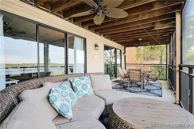 view of patio featuring ceiling fan, outdoor dining space, an outdoor hangout area, and a water view