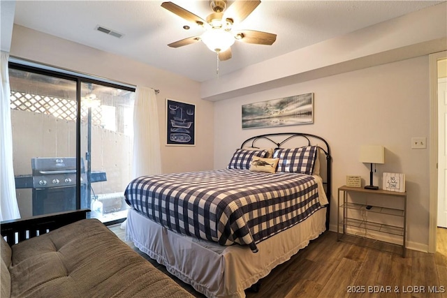 bedroom with visible vents, dark wood-type flooring, a ceiling fan, access to outside, and baseboards