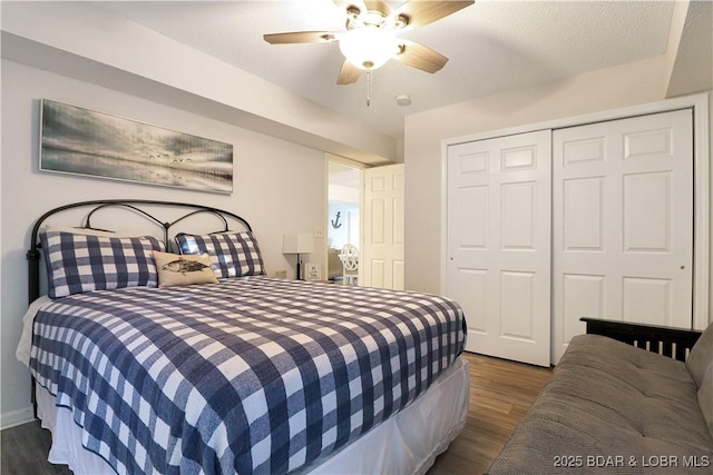 bedroom featuring a closet, dark wood finished floors, and a ceiling fan