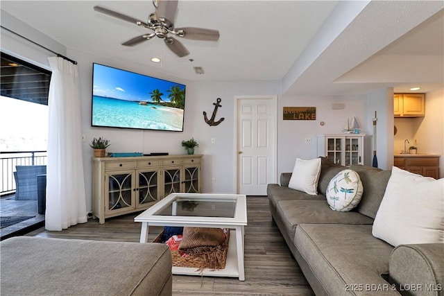 living room with ceiling fan, wood finished floors, and recessed lighting