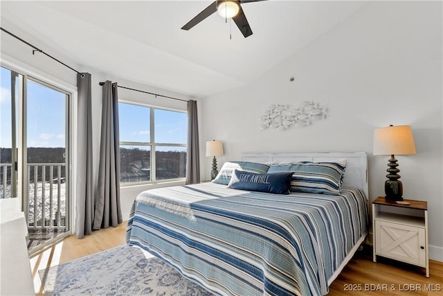 bedroom featuring lofted ceiling, access to exterior, ceiling fan, and wood finished floors