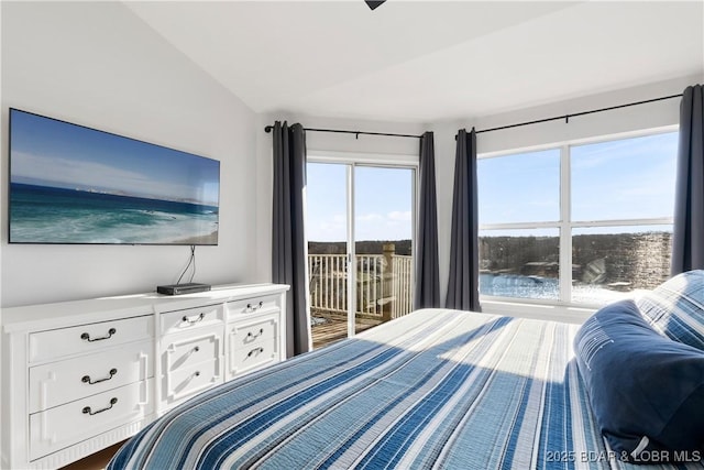 bedroom featuring lofted ceiling and access to outside