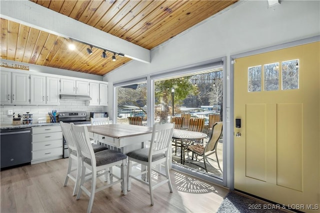 dining room with light wood-type flooring, vaulted ceiling with beams, wood ceiling, and track lighting