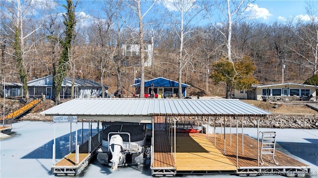 view of property's community featuring a carport, a floating dock, and boat lift