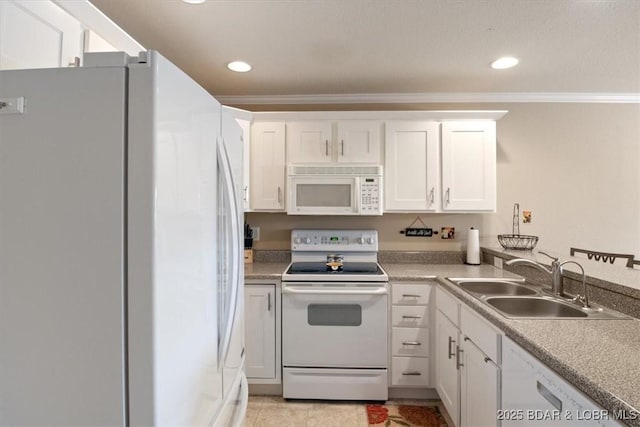 kitchen with white appliances, white cabinets, ornamental molding, a sink, and recessed lighting