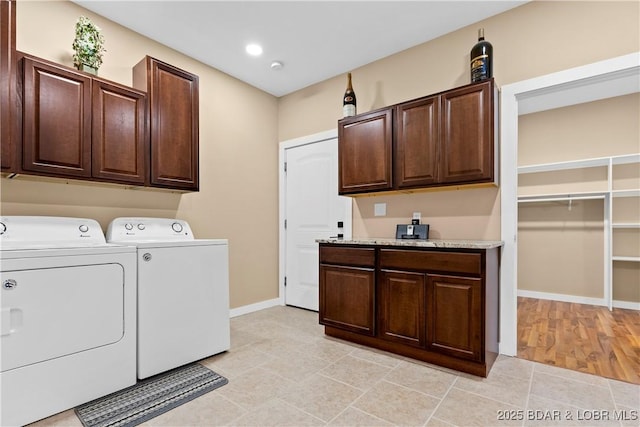 laundry area featuring cabinet space, baseboards, separate washer and dryer, and recessed lighting