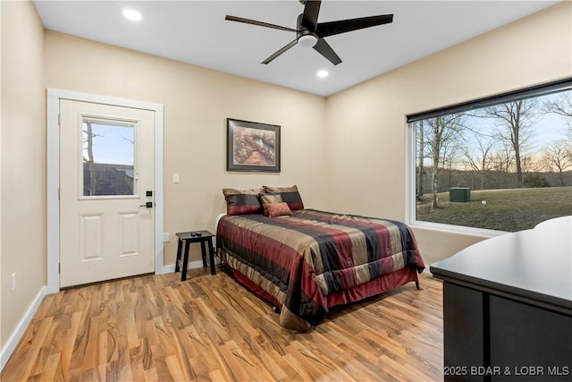 bedroom featuring baseboards, light wood finished floors, multiple windows, and recessed lighting