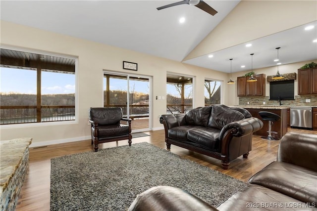 living room featuring recessed lighting, baseboards, and wood finished floors