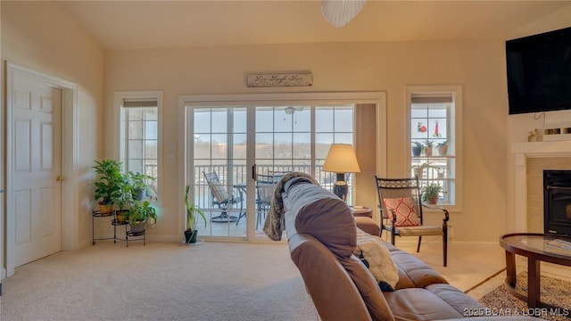 68 Lighthouse Rd Unit 511, Lake Ozark, MO 65049 - carpeted living room featuring plenty of natural light, a tiled fireplace, and baseboards