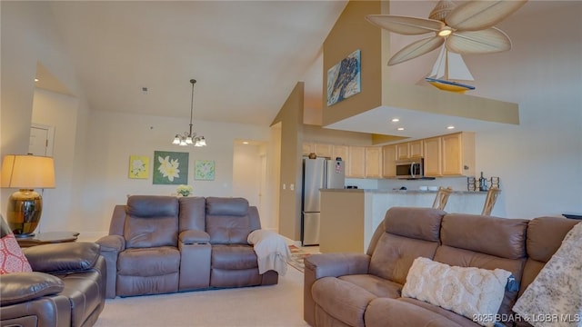 living room with light carpet, high vaulted ceiling, a chandelier, and recessed lighting