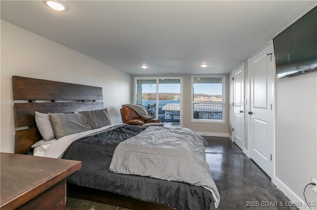 bedroom featuring access to exterior, recessed lighting, concrete floors, and baseboards