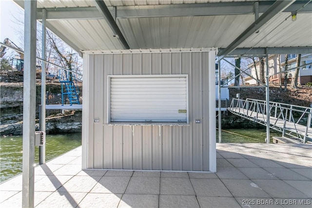 exterior space with a water view and driveway