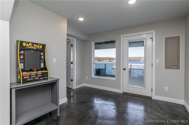 doorway to outside with finished concrete floors, recessed lighting, and baseboards