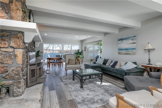 living room featuring recessed lighting, beamed ceiling, and light wood finished floors