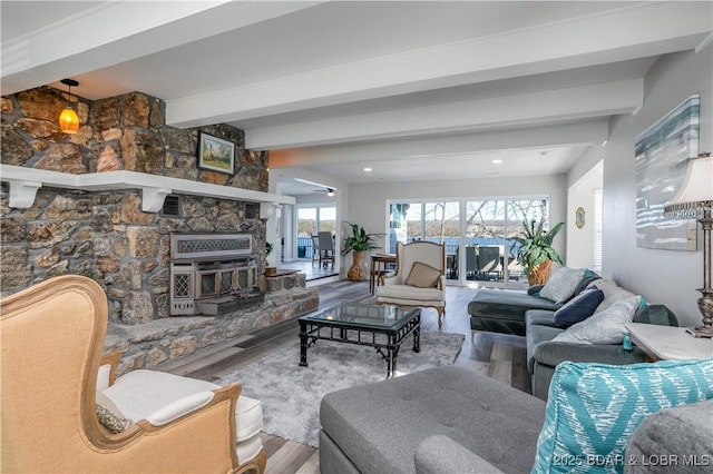 living area featuring beam ceiling and wood finished floors