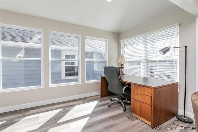 office with lofted ceiling, light wood finished floors, and baseboards