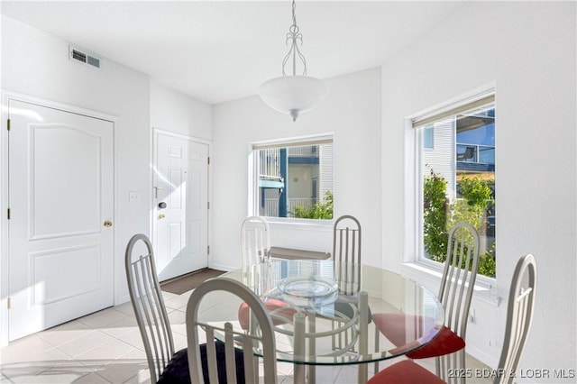 dining area featuring light tile patterned flooring and visible vents