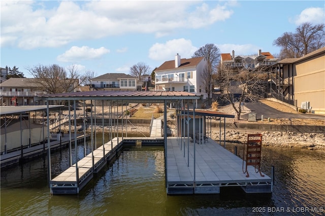 dock area with a water view and a residential view