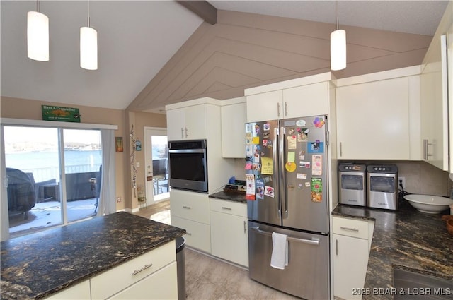 kitchen with pendant lighting, stainless steel appliances, lofted ceiling with beams, white cabinetry, and dark stone counters