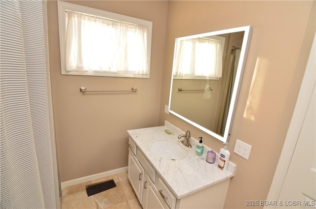 bathroom featuring tile patterned flooring, vanity, and baseboards