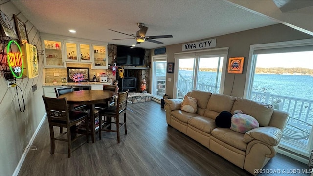 dining area featuring dark wood-style flooring, recessed lighting, a ceiling fan, a textured ceiling, and baseboards